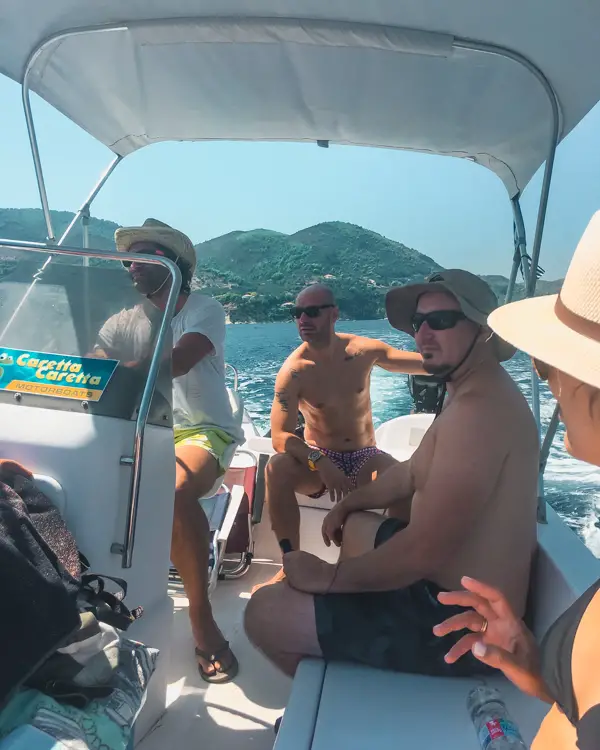 picture of me and friends on a boat in Zakynthos. Riding a boat around the Keri Caves is one of the top things to do in Zakynthos.