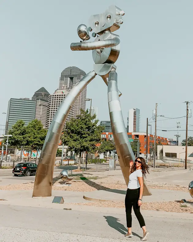 Me poising in front of The Traveling Man sculpture one of the best places to take pictures in Dallas. 