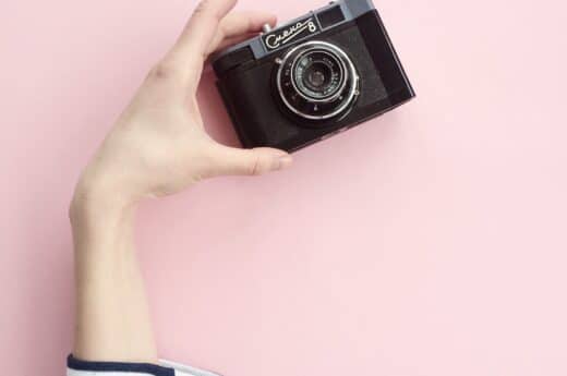 Free travel Lightroom presets photo of a woman holding a professional camera.