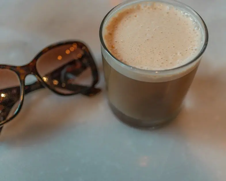 The Draft Latte on a table next to my sunglasses
