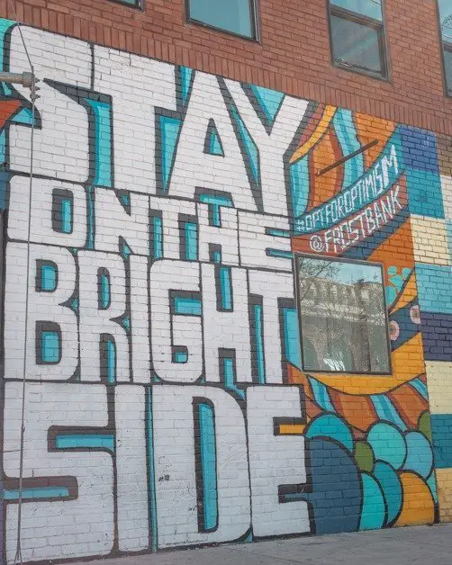 Wall mural in Deep Ellum that says "Stay On The Bright Side."