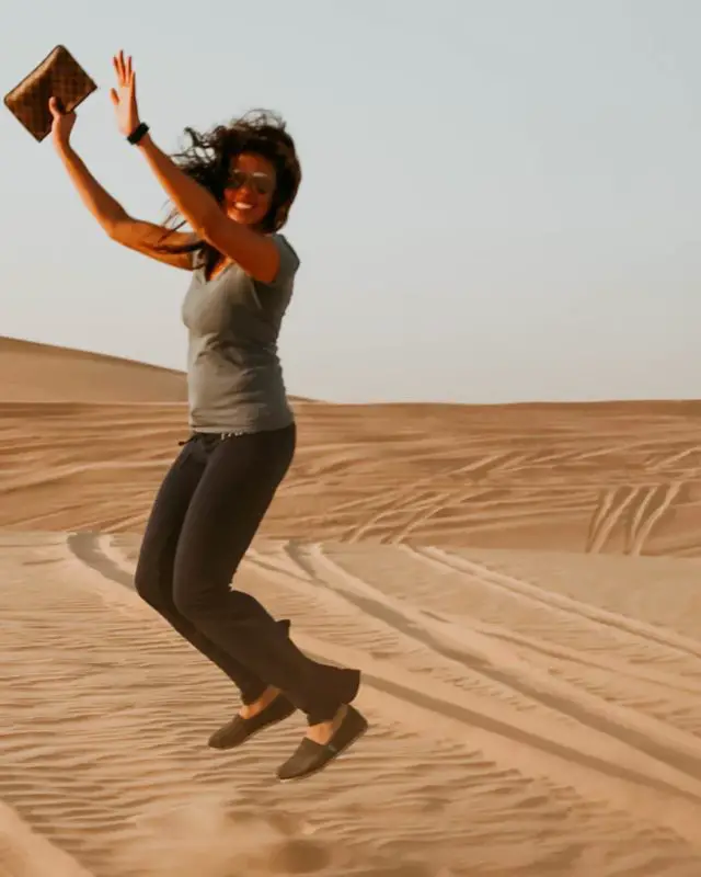 me jumping in the middle of the desert during my Abu Dhabi day trip from Dubai