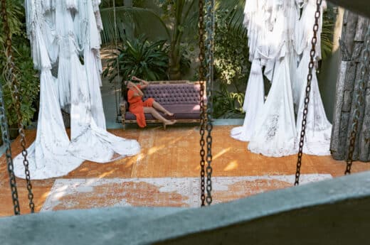 Aerial view of me posing on a sofa at Casa Malca one of the top Tulum Instagram spots