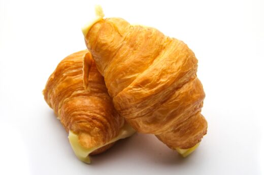 Croissant captions photo of two croissants.