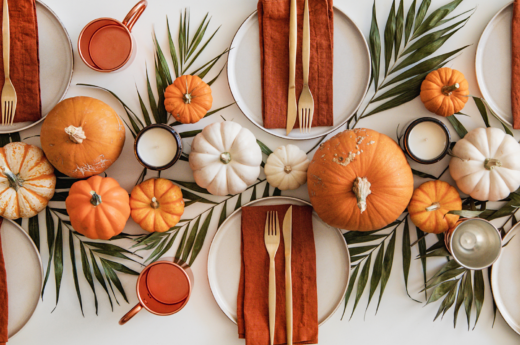 Thanksgiving captions photo of a beautifully decorated table for Thanksgiving.