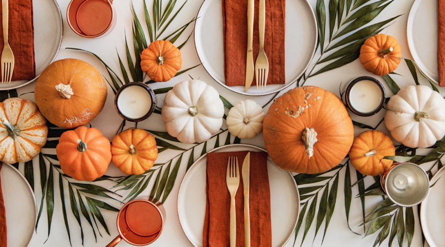 Thanksgiving captions photo of a beautifully decorated table for Thanksgiving.